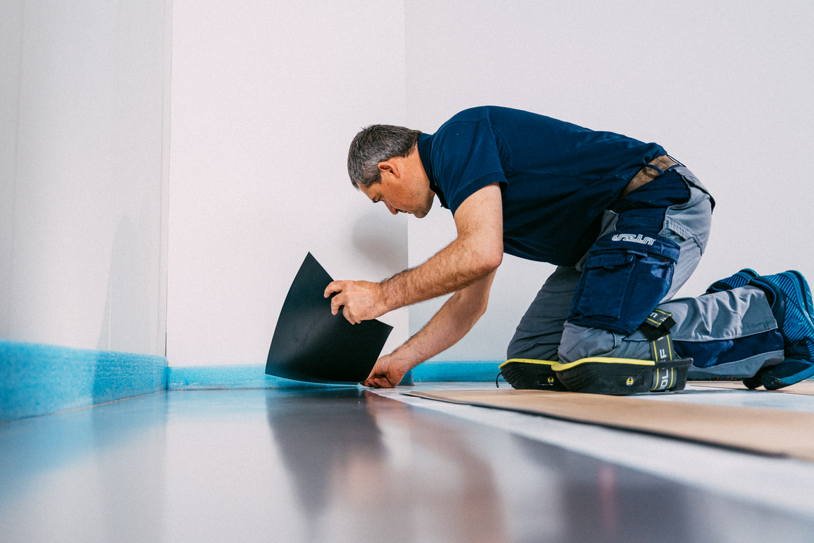 Installing a plank of LVT flooring onto UZIN Plurafilm Hydro DPM & Tape Installing a plank of LVT flooring onto UZIN Plurafilm Hydro DPM & Tape