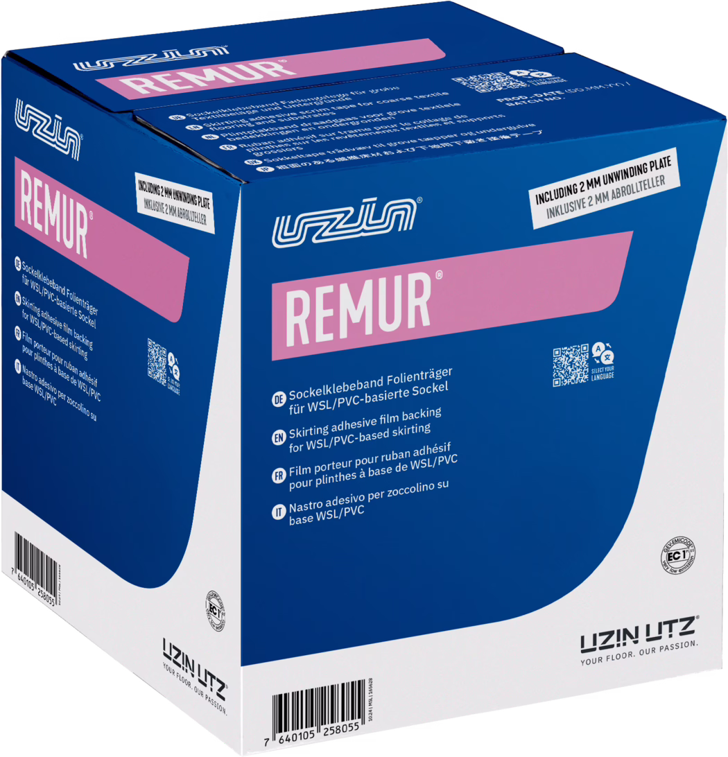 UZIN_Dummy_Remur-carton_2026-02 Photograph of a retail packaging box for REMUR skirting adhesive film backing by UZIN UTZ. The cardboard box is predominantly deep blue with white panels and large pink branding that reads “REMUR” on the front and side. The UZIN logo appears in white near the top. Product usage information and short multilingual descriptions are printed on the front in small white text, and a label near the top edge states “INCLUDING 2 MM UNWINDING PLATE”. A QR code and certification icons are visible on the front panel, along with a barcode on the lower edge. The box is shown at a three-quarter angle, revealing the top, front, and left side, and it sits against a plain white background. The overall appearance communicates a professionally packaged floor installation accessory: the design uses bold color blocks (blue, white, pink), clear brand marks, and technical copy indicating the item is intended as a film carrier for WSL/PVC-based skirting.